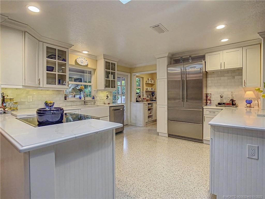 9 Ridgeview Road North Stuart, FL 34996 - Photo 5 of 20 a kitchen with stainless steel appliances a sink and a refrigerator