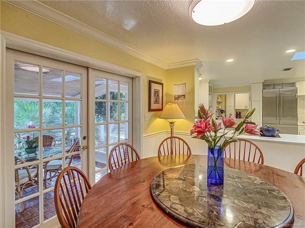 9 Ridgeview Road North Stuart, FL 34996 - Photo 8 of 20 a dining room with furniture potted plants and wooden floor
