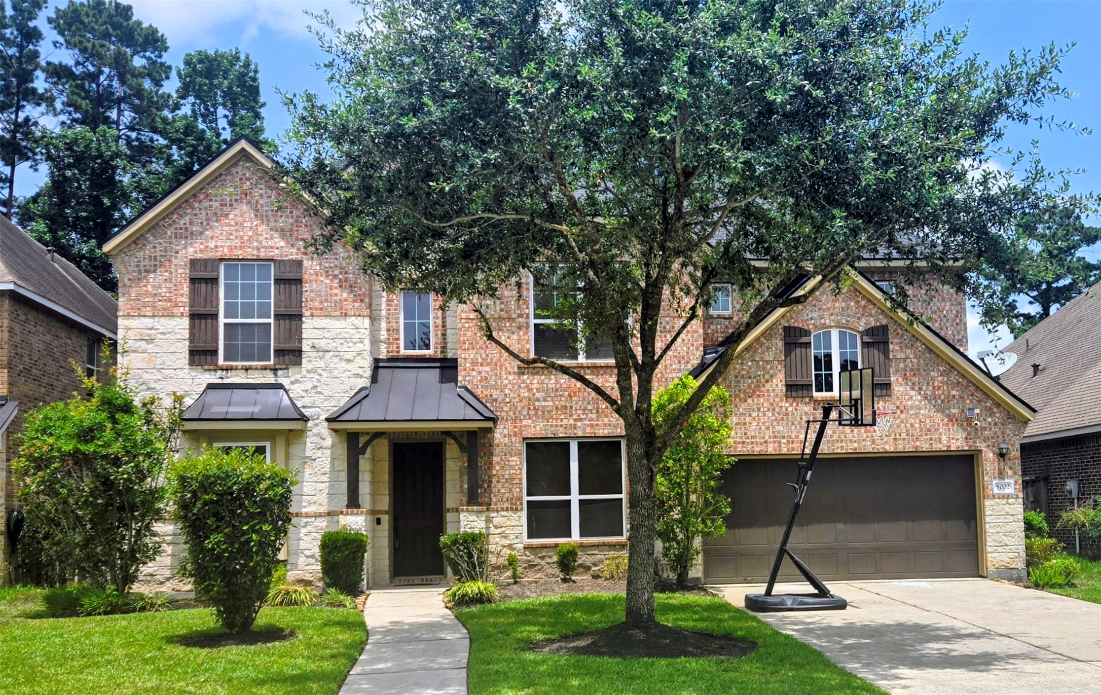 5002 Sawmill Terrace Lane Spring, TX 77389 - Photo 44 of 50 a front view of a house with a yard and potted plants