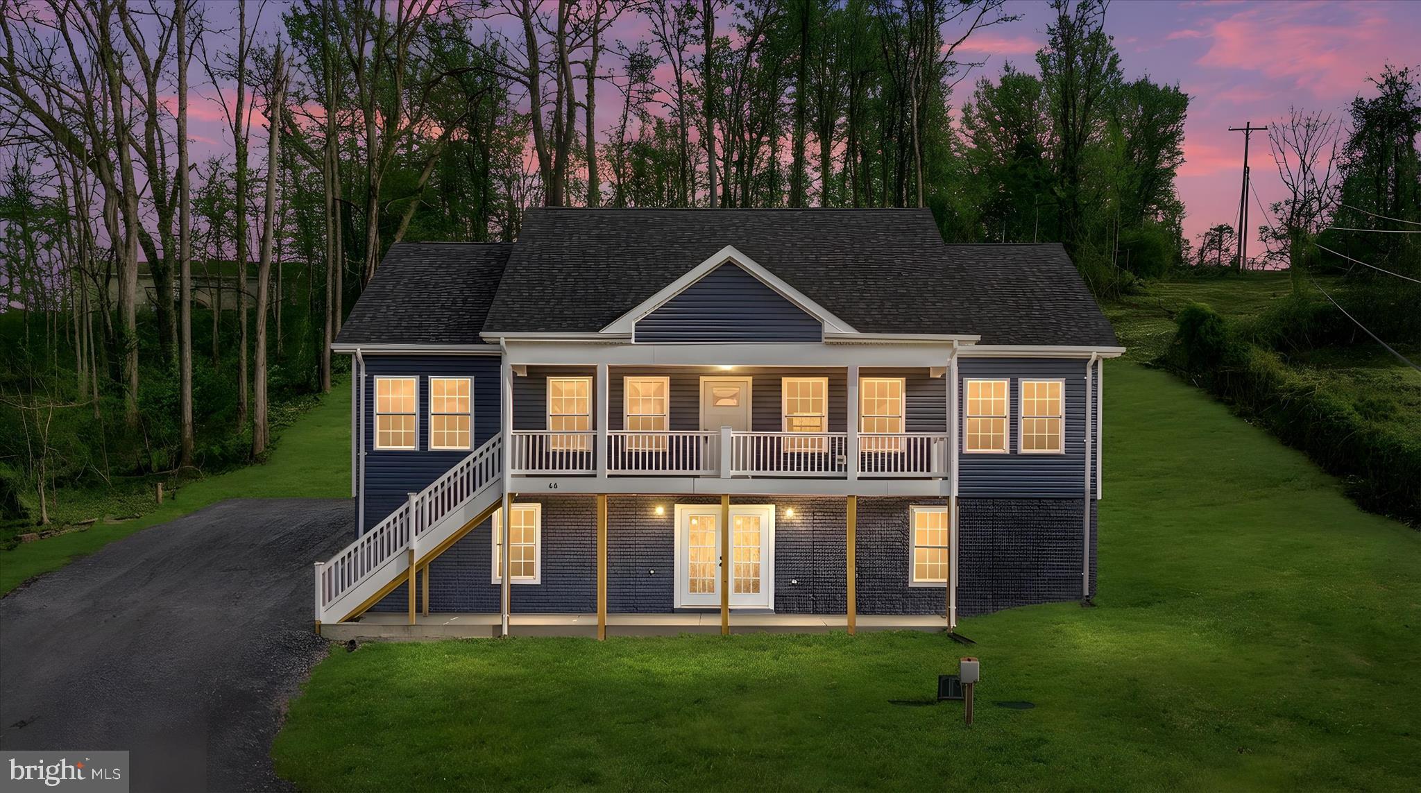 a view of a big house with a big yard and large trees