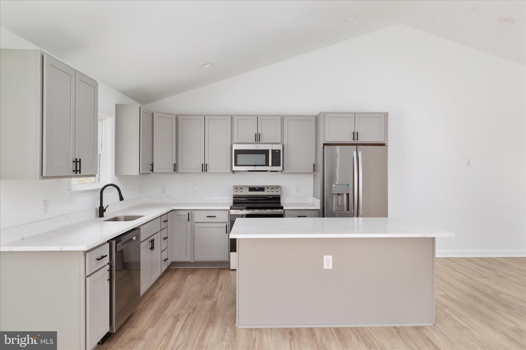 66 Bluejay Court Front Royal, VA 22630 - Photo 20 of 81 a kitchen with stainless steel appliances granite countertop a sink a stove top oven a refrigerator with white cabinets and wooden floor