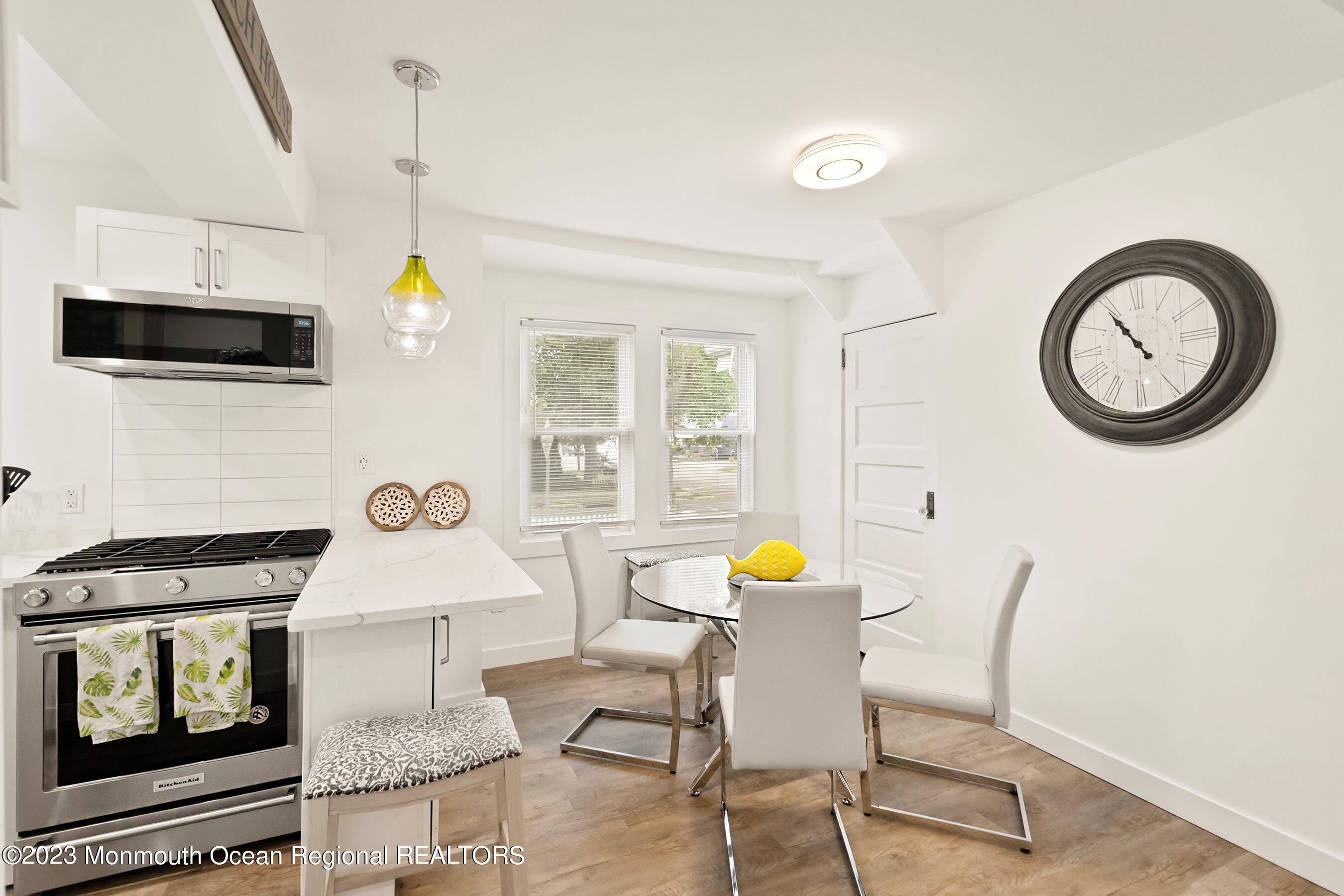 1401 B Street, Unit DOWNSTAIRS Belmar, NJ 07719 - Photo 4 of 12 a view of a kitchen with a table and a stove