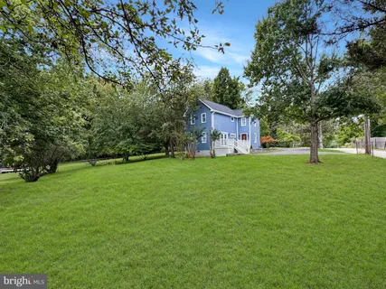 an empty room with wooden floor and a window