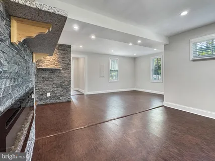an empty room with a ceiling fan and carpet