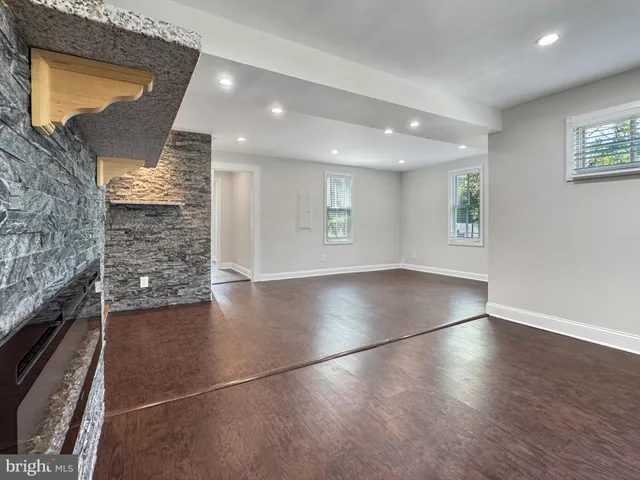 an empty room with a ceiling fan and carpet