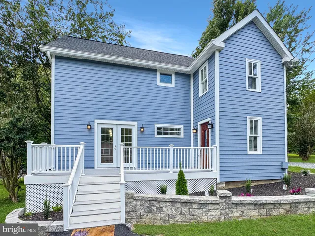 a front view of a house with a garden and yard