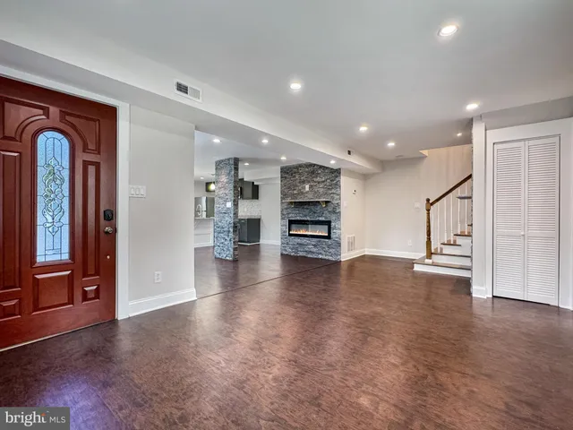 a bathroom with a granite countertop toilet sink and mirror