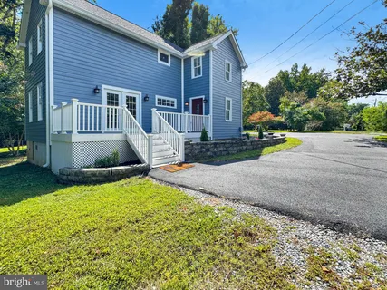 a view of grassy field with benches and trees all around