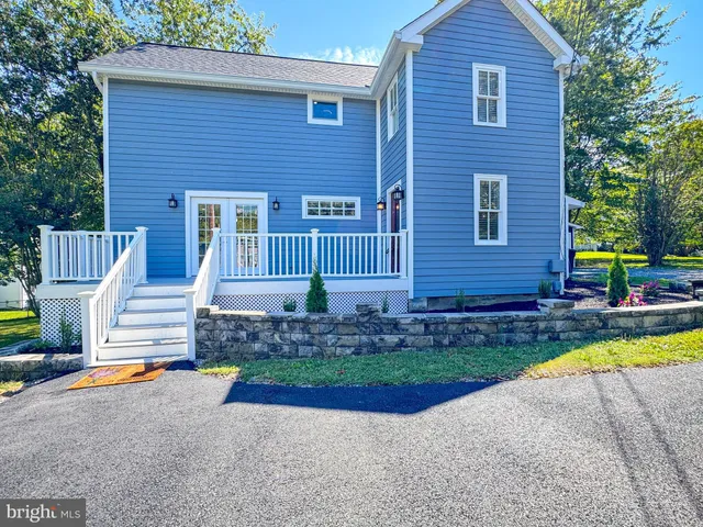 a kitchen with stainless steel appliances granite countertop a sink a stove and a wooden floors