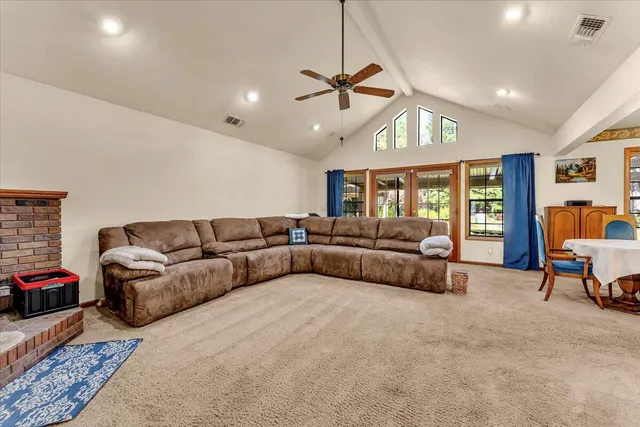 a bathroom with a granite countertop sink a toilet a mirror and shower