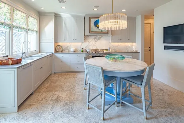 a kitchen with granite countertop a sink and white appliances