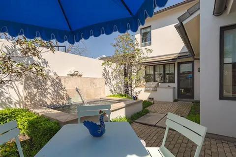 a view of a patio with table and chairs and potted plants