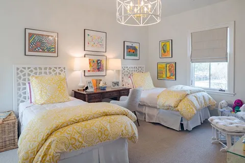 a bedroom with two beds and a couch
