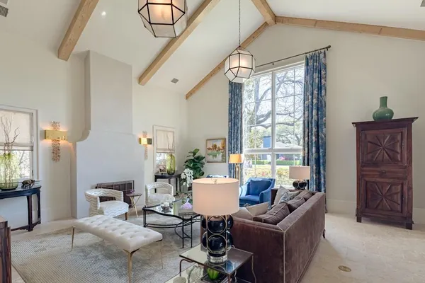 a living room with furniture and large windows