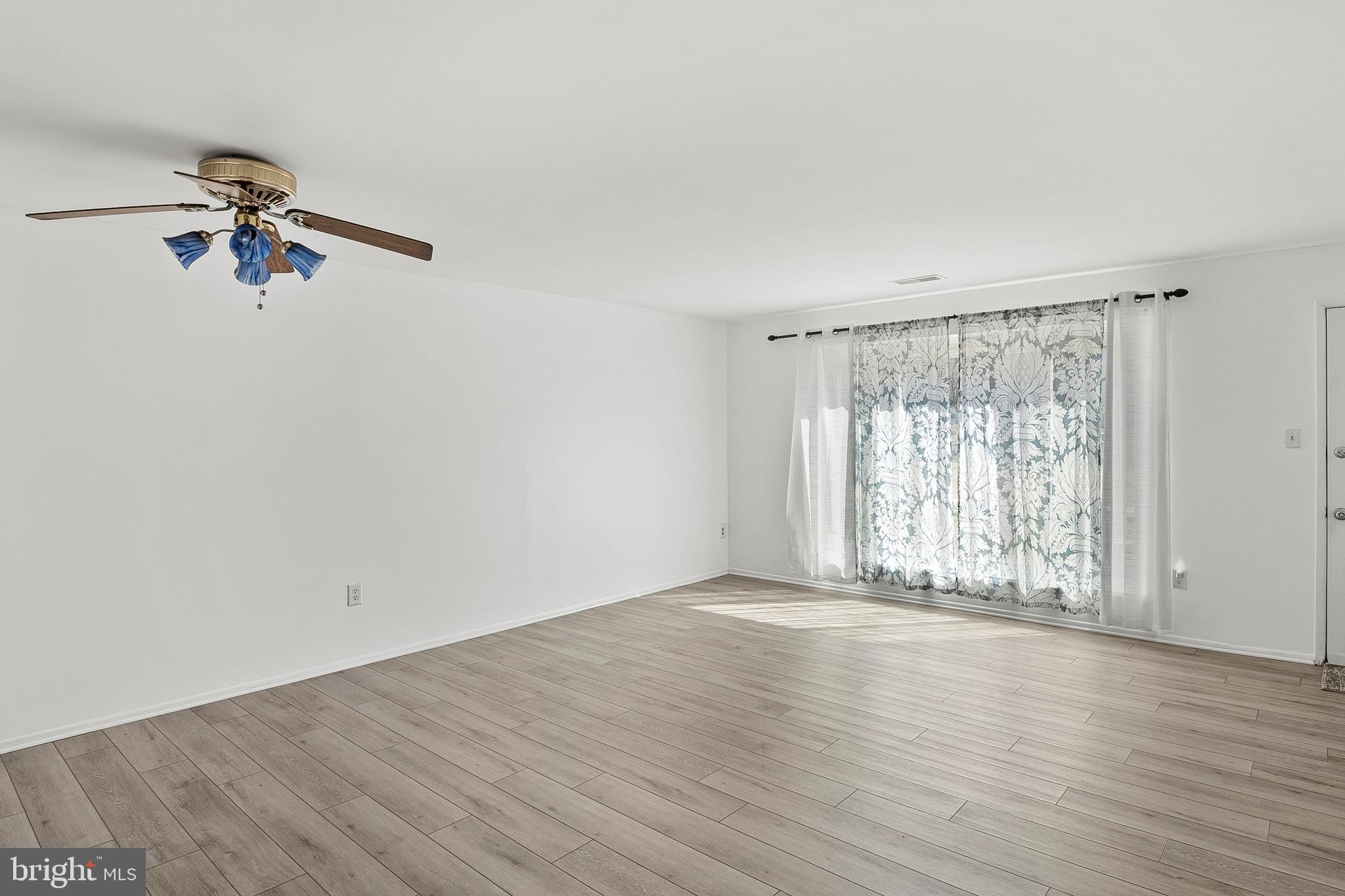 1619 Fendall Court Crofton, MD 21114 - Photo 4 of 21 wooden floor in an empty room with a window