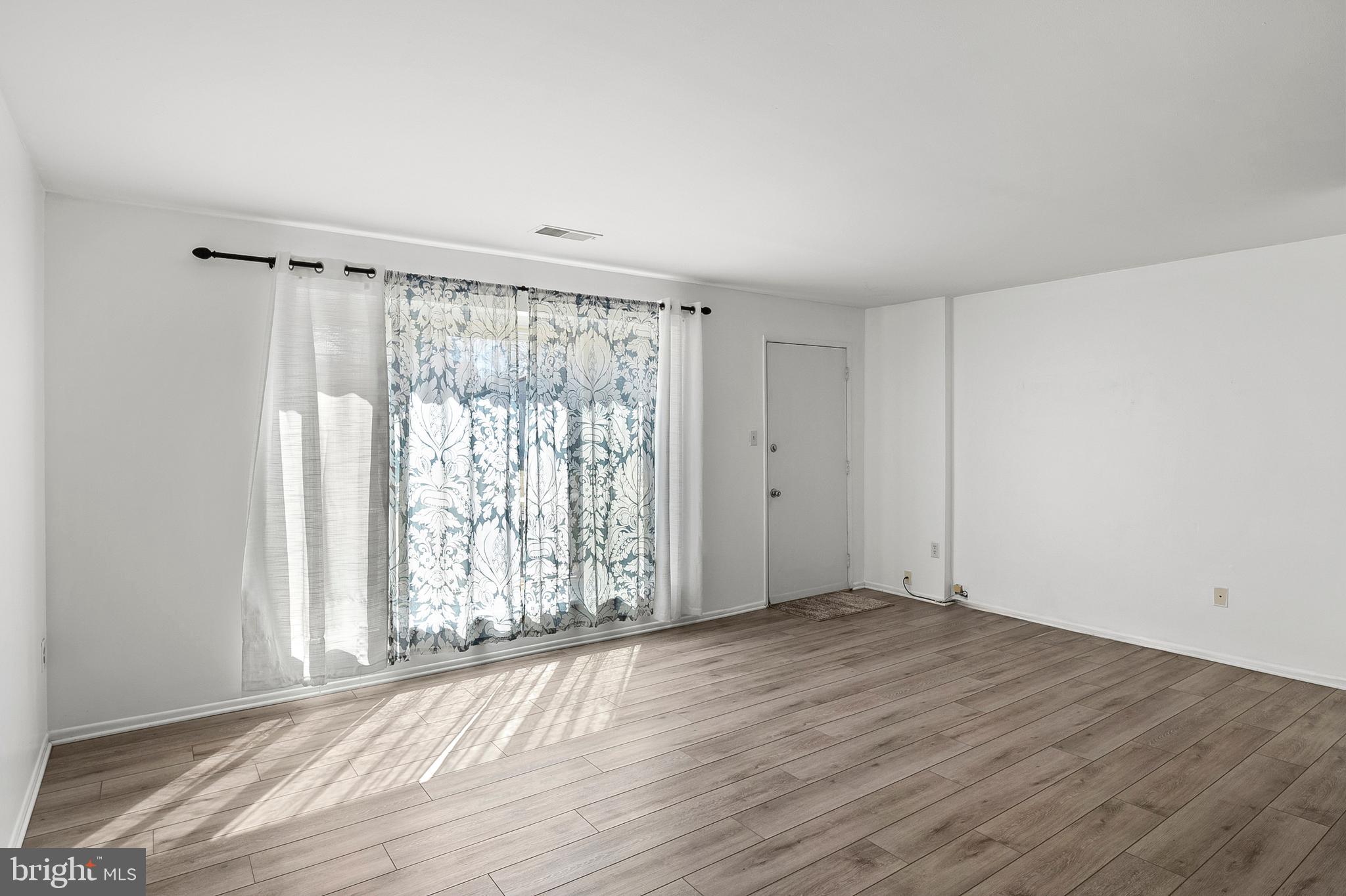 1619 Fendall Court Crofton, MD 21114 - Photo 7 of 21 an empty room with wooden floor and windows