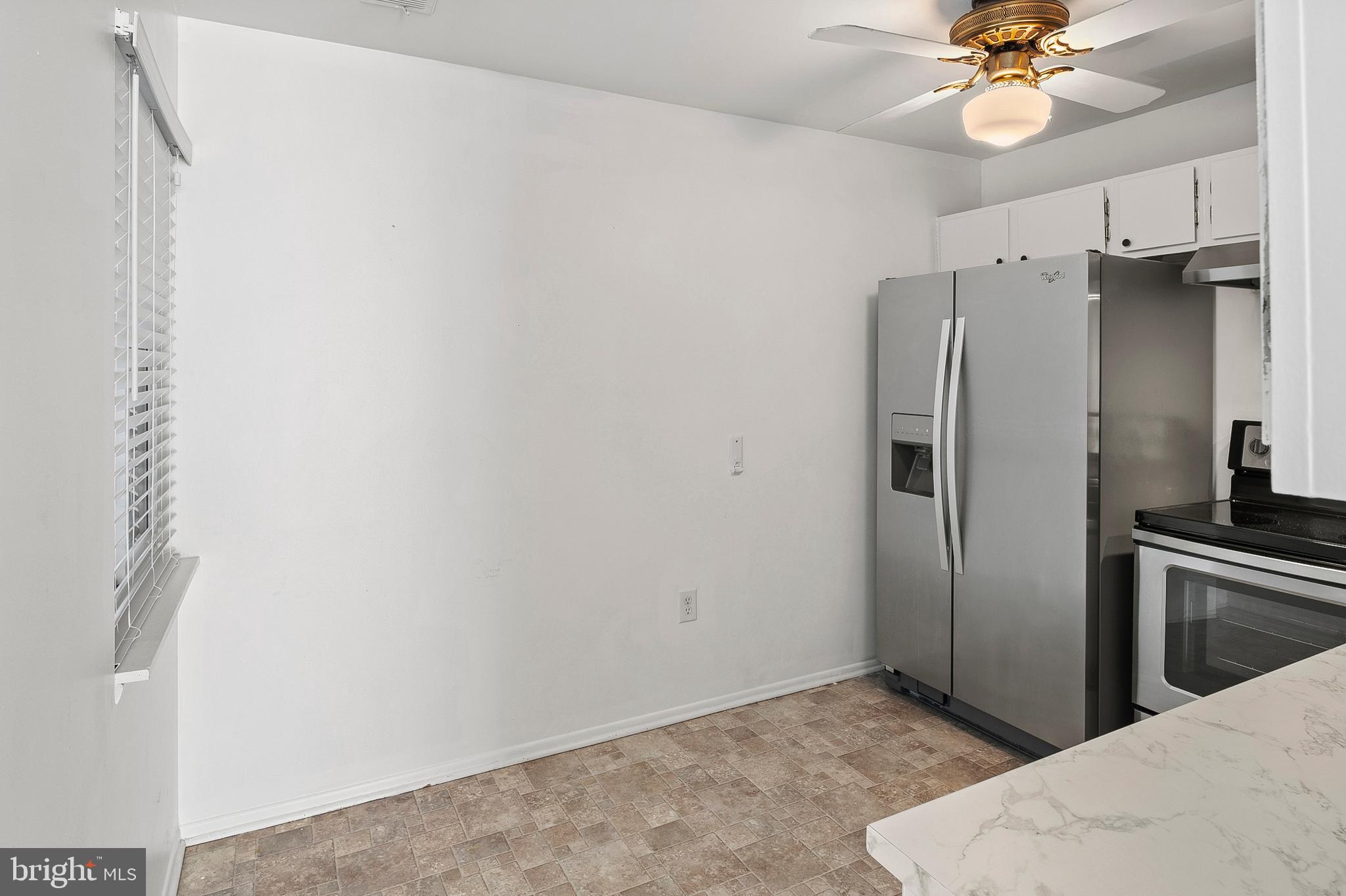 1619 Fendall Court Crofton, MD 21114 - Photo 9 of 21 a view of a kitchen with a ceiling fan and a refrigerator
