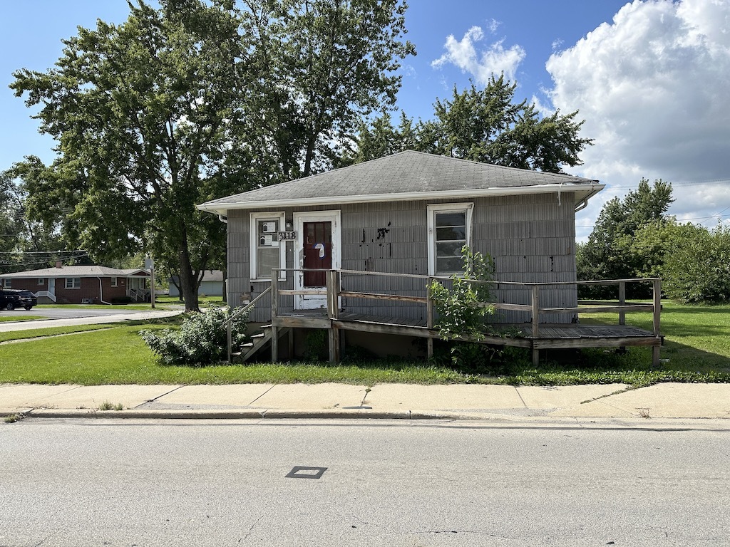 3118 Chicago Road Steger, IL 60475 - Photo 1 of 14 a front view of a house with a garden