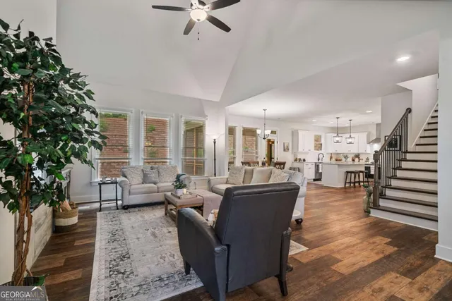a living room with furniture and wooden floor
