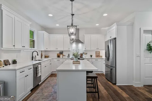 a kitchen with refrigerator a sink and cabinets