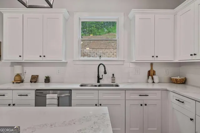 a kitchen with cabinets appliances and a window