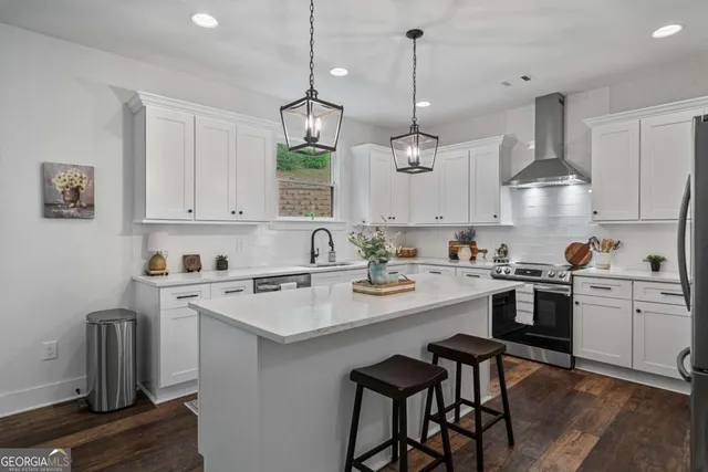 a kitchen with kitchen island granite countertop a sink a center island and cabinets