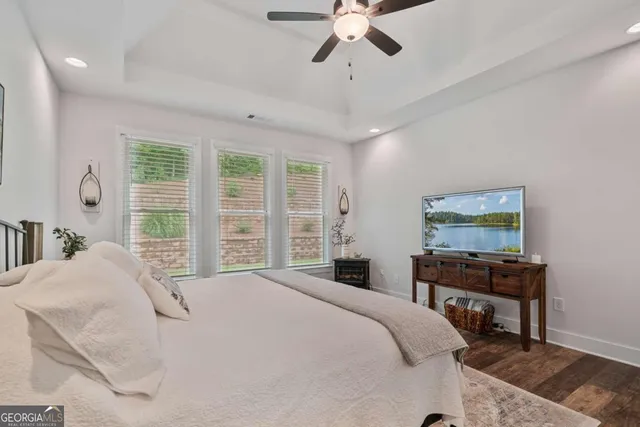 a bedroom with a bed window and a chandelier