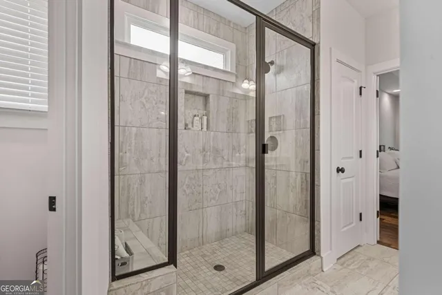 a bathroom with a glass shower door
