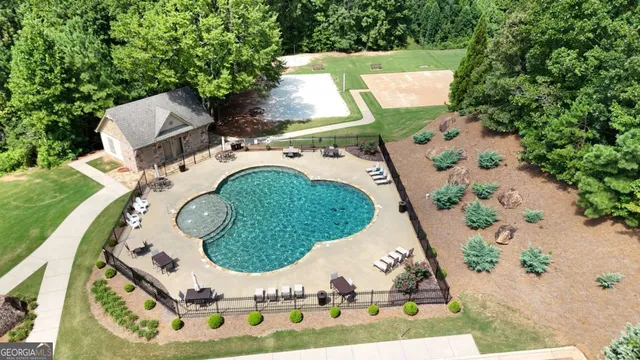 an aerial view of a house with a swimming pool