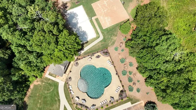an aerial view of a residential houses with yard