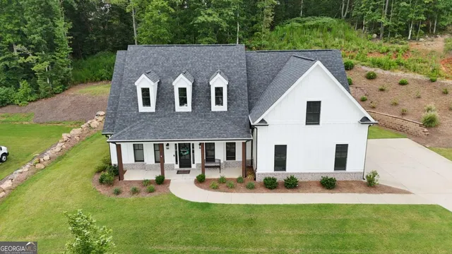 a aerial view of a house with swimming pool next to a yard