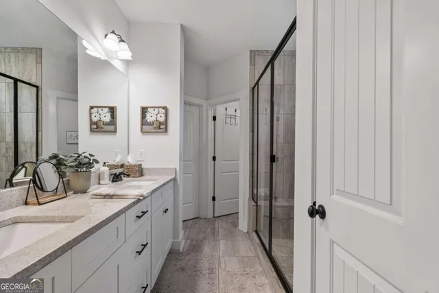 a bathroom with double sink and a mirror