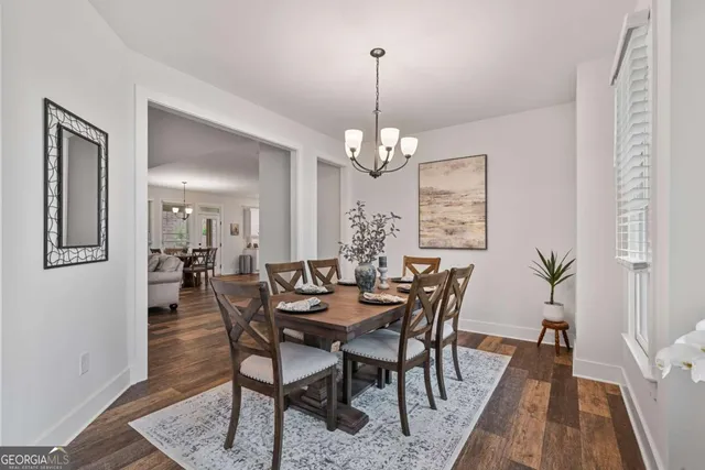 a view of a dining room with furniture and wooden floor