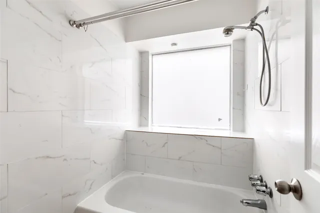 a bathroom with a toilet sink a mirror and shower