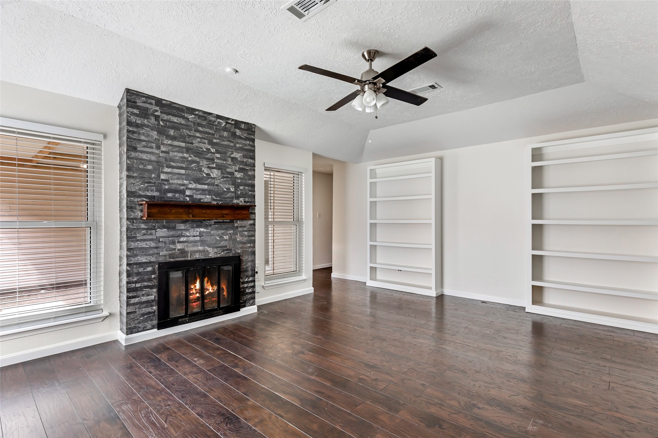 2810 Spring Dusk Drive Spring, TX 77373 - Photo 7 of 30 a view of an empty room with a fireplace and a window