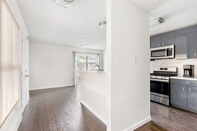 a kitchen with stainless steel appliances granite countertop a refrigerator and a stove top oven