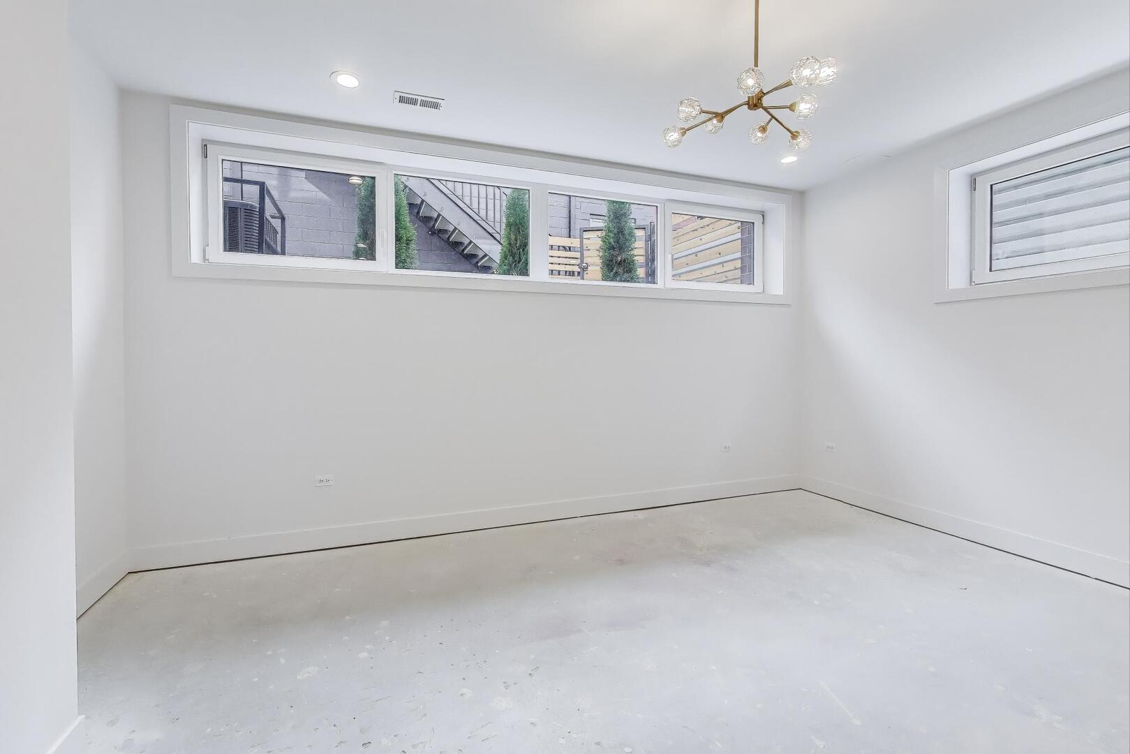 2147 West Adams Street, Unit 1S Chicago, IL 60612 - Photo 16 of 44 a view of an empty room with a window