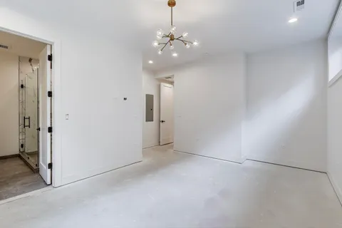a view of a chandelier in big room and chandelier fan