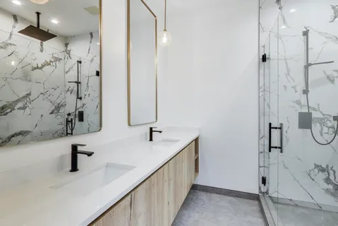 a bathroom with a double vanity sink and a mirror