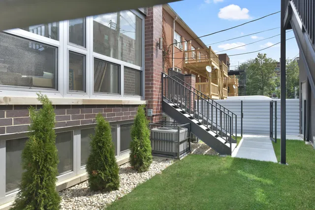 a view of a house with a yard and sitting area