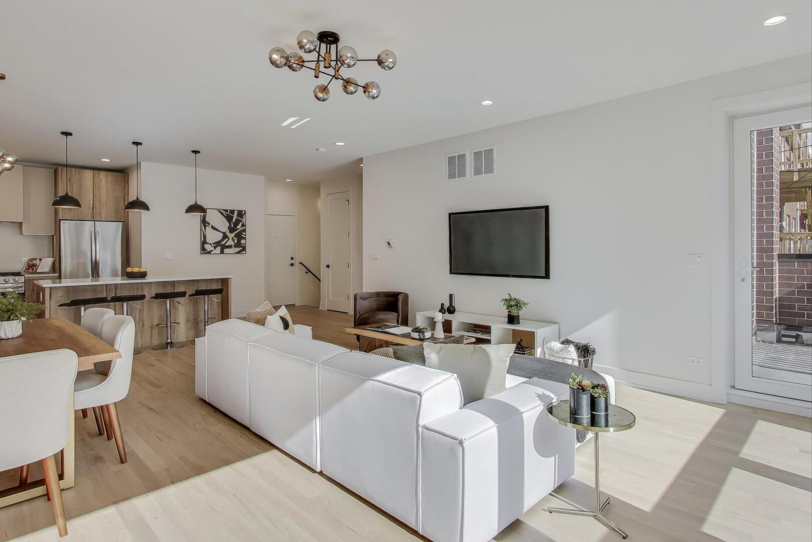 2147 West Adams Street, Unit 1S Chicago, IL 60612 - Photo 5 of 44 a living room with furniture and a flat screen tv