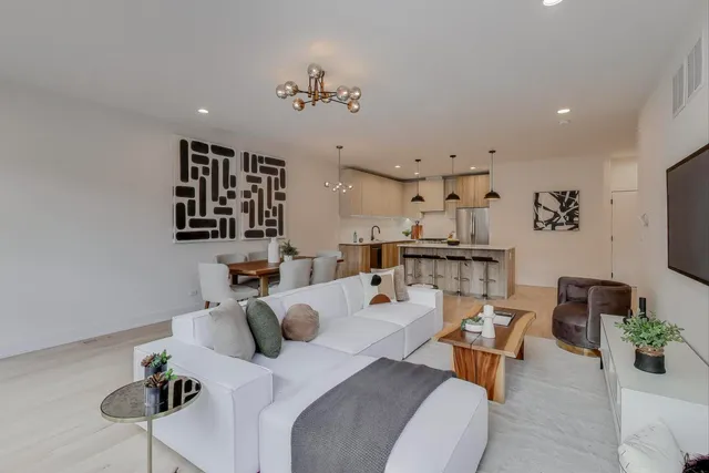 a living room with furniture and a chandelier