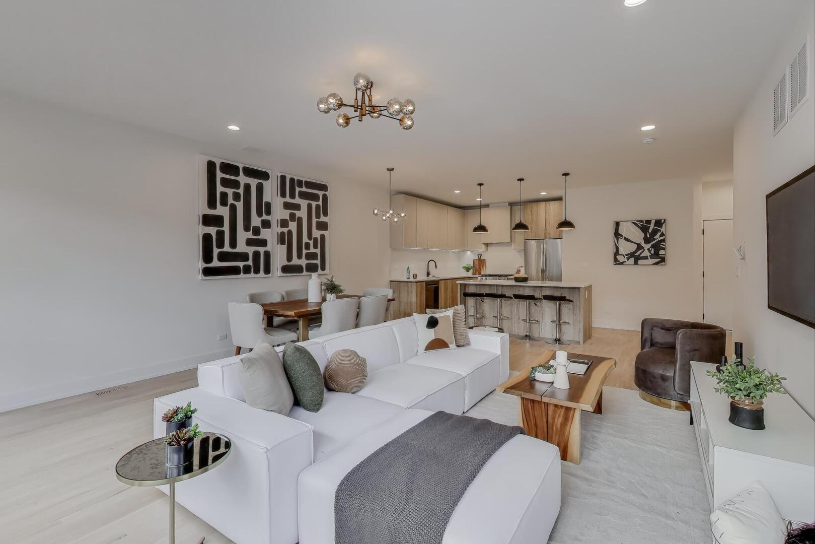 2147 West Adams Street, Unit 1S Chicago, IL 60612 - Photo 6 of 44 a living room with furniture and a chandelier