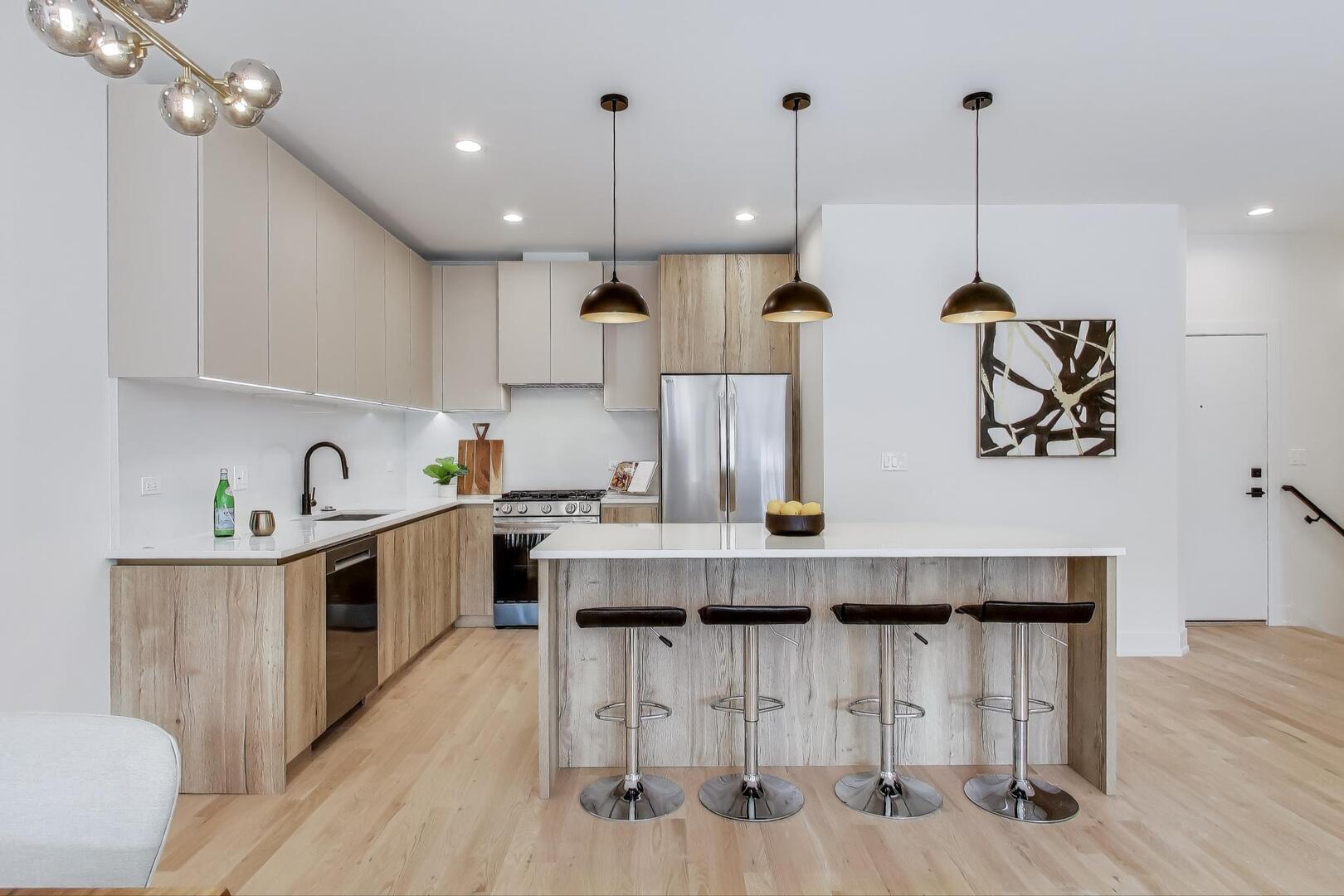 2147 West Adams Street, Unit 1S Chicago, IL 60612 - Photo 7 of 44 a kitchen with kitchen island granite countertop a table chairs sink and cabinets