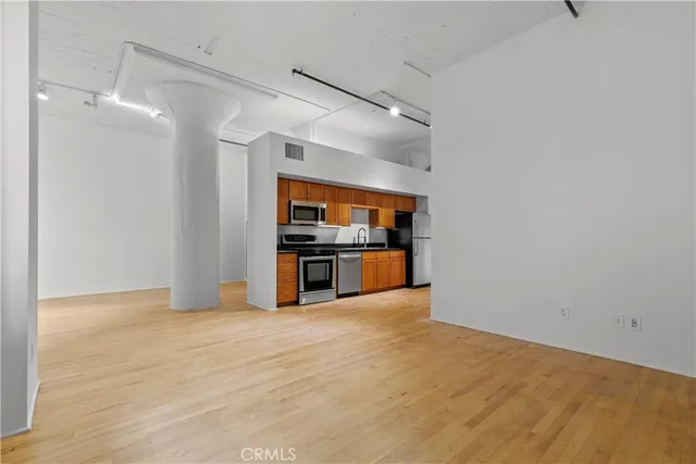 a view of kitchen with microwave and cabinets