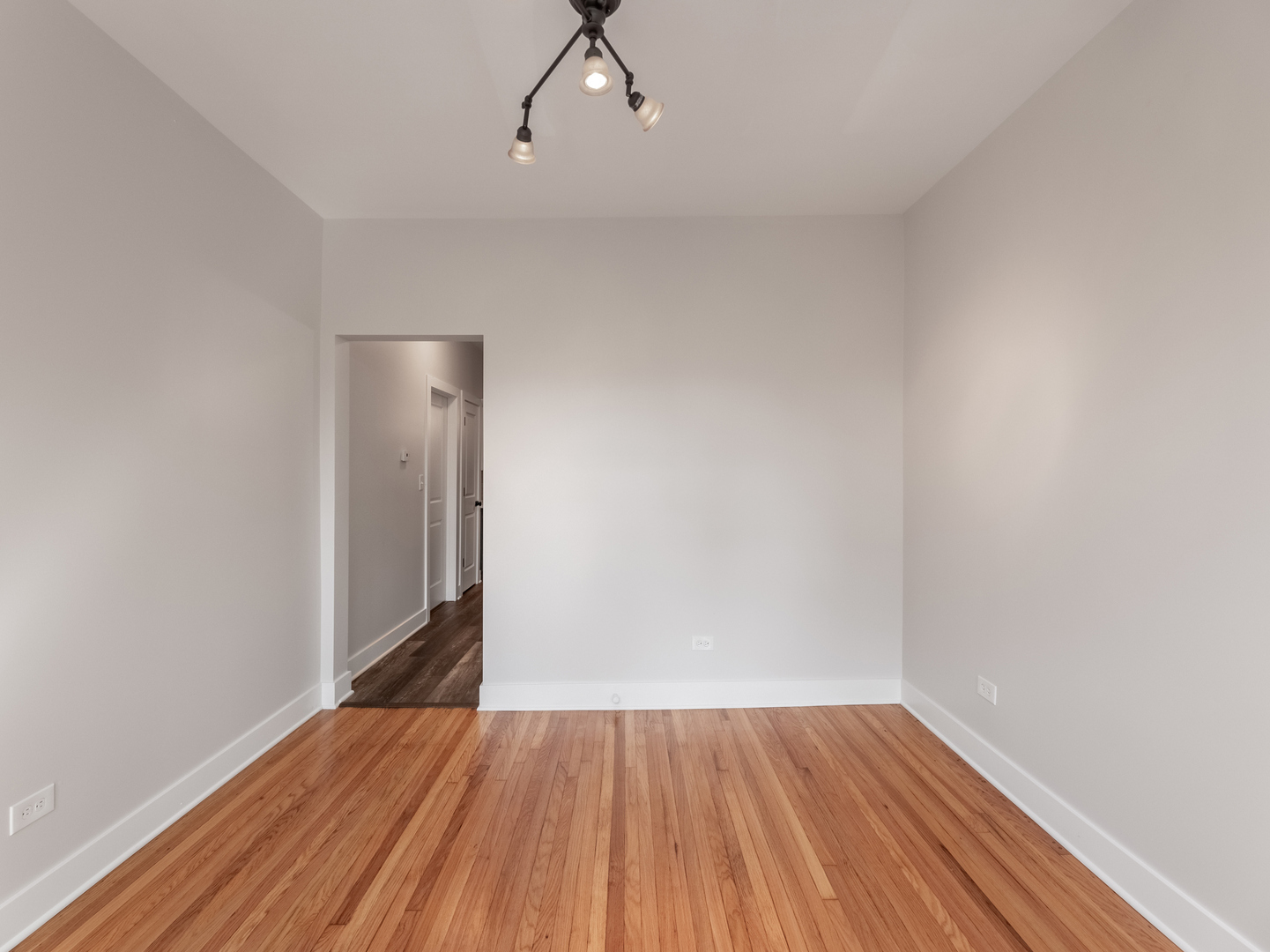 2940 West Pershing Road Chicago, IL 60632 - Photo 3 of 11 a view of an empty room with wooden floor