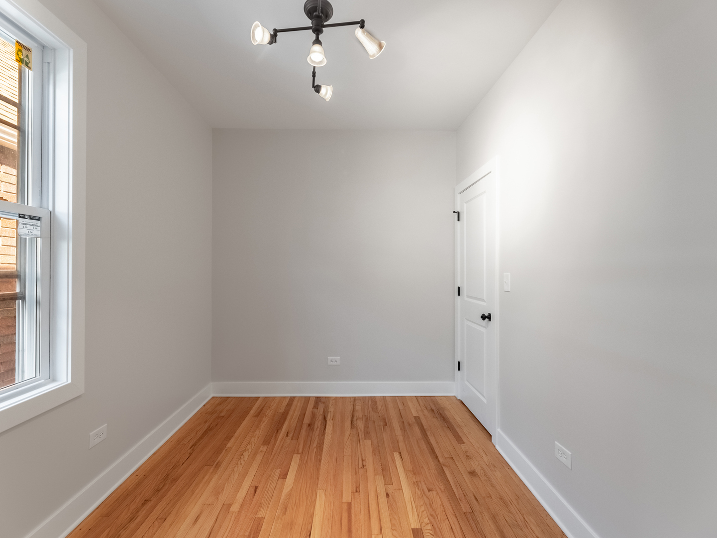2940 West Pershing Road Chicago, IL 60632 - Photo 8 of 11 wooden floor in an empty room with a window