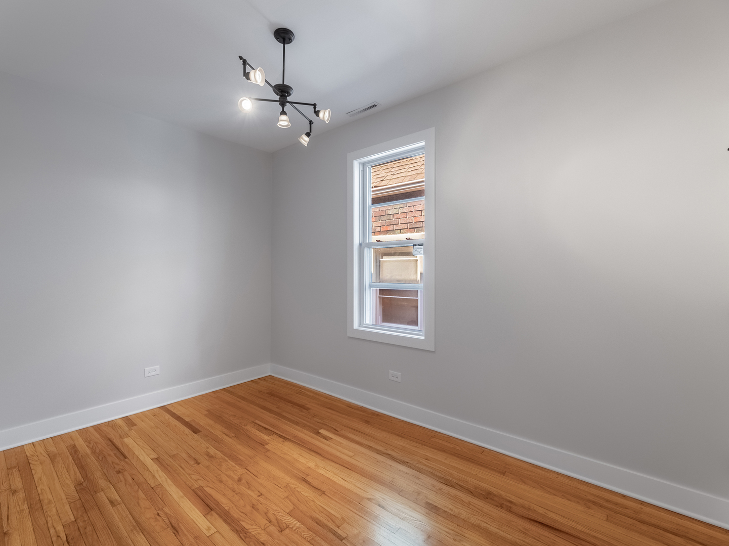 2940 West Pershing Road Chicago, IL 60632 - Photo 9 of 11 wooden floor in an empty room with a window