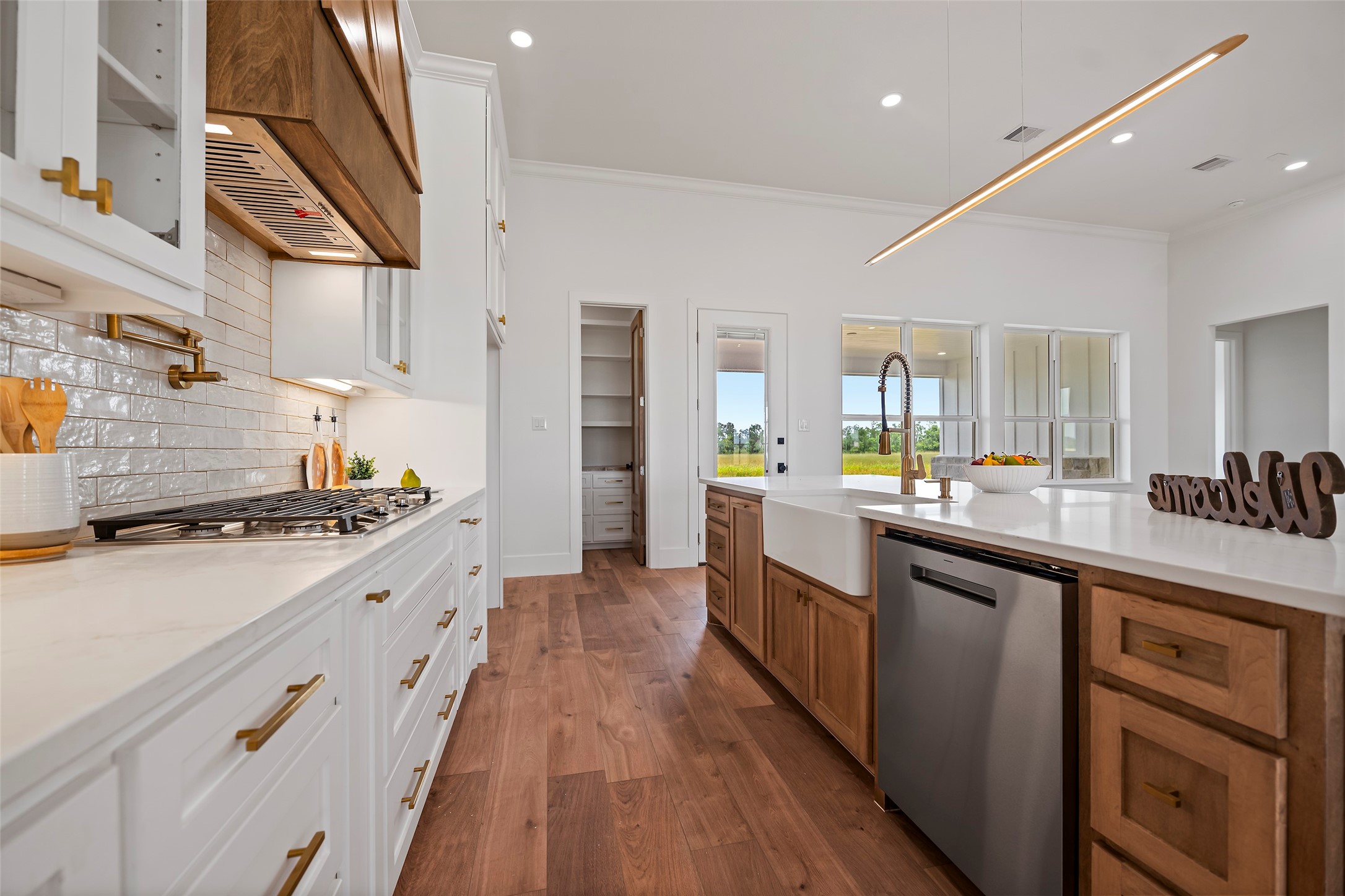413 Chuckwagon Trail Angleton, TX 77515 - Photo 13 of 46 a large kitchen with stainless steel appliances granite countertop a lot of counter space and wooden floors