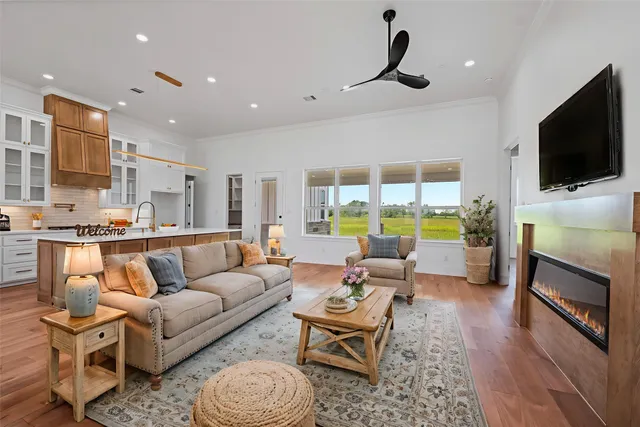 a living room with fireplace furniture and a flat screen tv